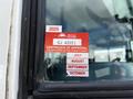 Red certification sticker on a window of a 2022 Blue Bird BB Conventional bus showing approval details for British Columbia