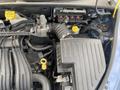 Close-up of the engine compartment of a 2007 Chrysler PT Cruiser showing the engine components and hoses