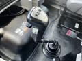 Close-up of the gear shift lever in a 2017 International WorkStar 7600 featuring a black grip and silver markings