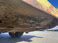 Underside view of a 2010 Kubota F3680 showing dirt and debris accumulation on the chassis and cutting deck components