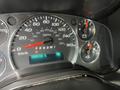 Dashboard of a 2014 Chevrolet Express displaying speedometer fuel gauge and odometer with the reading of 164110 km