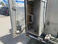 A silver 2007 Morgan Olson Workhorse W42 vehicle with an open side compartment showing interior storage and equipment attachments