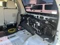 Interior view of a 2013 Ford Expedition showing the rear cargo area with removed panels and exposed wiring and components