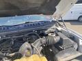 A 2017 Ford F-150 with its hood open revealing the engine compartment featuring various engine components and hoses