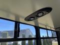 Ceiling lights inside a 2020 Chevrolet Express with two round fixtures and a rectangular vent speaker