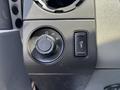 A control panel featuring knobs and buttons for various functions in a 2015 Ford F-750 interior
