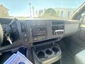 Interior dashboard of a 2007 Chevrolet Express showing the steering wheel, control panel, audio system, and cup holders