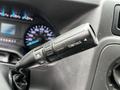 Close-up of a 2021 Ford E-450 gear shift lever with a button labeled Tow/Haul