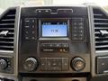 Dashboard of a 2022 Ford F-550 featuring a large display screen with radio and media controls along with various buttons and knobs for settings and volume