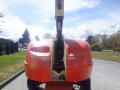 A 2008 JLG Boom Lift featuring a large orange lift platform and a telescoping arm positioned upright