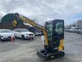 A 2024 AGT Industrial H13R Mini Excavator with a compact design features a yellow and black color scheme and a hydraulic arm extended upward ready for operation