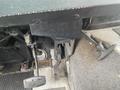 Interior view of a 2012 Ford Econoline showing the driver's foot pedals including the accelerator brake and a pull lever on the side