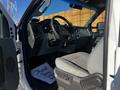 Interior view of a 2011 Ford F-350 SD showing the steering wheel dashboard and driver's seat with a welcome mat on the floor