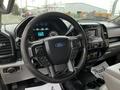 Interior view of a 2016 Ford F-150 highlighting the steering wheel dashboard and control panel with Ford branding and various indicators