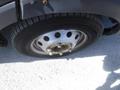 A close-up of a 2017 Ford Transit wheel showing a silver rim with multiple lug nut openings and a partially worn tire tread