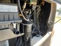 Engine compartment of a 2008 Newmar Canyon Star 36 Foot Class A Motorhome with various components like hoses wires and filters visible