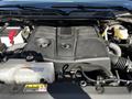 Engine compartment of a 2023 Toyota Tundra showing the large engine cover and various engine components