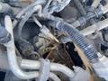 A 2013 Ford Expedition engine with various visible hoses and cables tangled around metal components