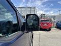 2015 Ford F-150 pickup truck with a side mirror in focus showcasing a blue exterior and rugged design