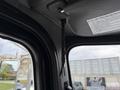 A braided strap hanging from the roof of a vehicle's interior