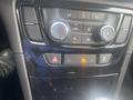Dashboard controls of a 2018 Buick Encore featuring climate control knobs and various buttons for vehicle settings