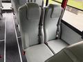 Interior seating of a 2016 International CE300 school bus with gray seats and seat belts for safety