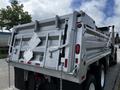 A metallic 2017 International WorkStar 7600 dump truck with a distinctively shaped bed and reflective safety decals on the rear side