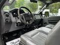 Interior of a 2011 Ford F-550 with gray leather seats and a steering wheel visible along with dashboard controls and gear shifter