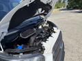A 2016 Ford Transit van with its hood open displaying the engine compartment and various components