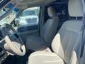 The interior of a 2013 Ford Expedition featuring beige fabric seats and a steering wheel visible from the driver's side