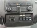 Dashboard of a 2012 Ford F-450 SD featuring air conditioning controls and multiple auxiliary switches