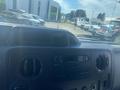 Dashboard of a 2009 Ford Econoline featuring a radio and air conditioning controls