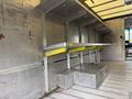 Interior of a 2012 Ford Econoline with metal shelving and a raised platform designed for storage or cargo management