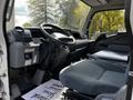 Interior of a 2015 Mitsubishi Fuso FE showing driver's seat and dashboard with controls and touchscreen display