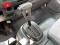 The image shows the gear shifter of a 2016 Isuzu NQR with a black knob and a label indicating the gear positions