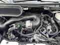 Close-up view of the engine compartment of a 2023 Ford Transit showing various components including tubes wires and an air intake system