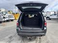 A 2015 Dodge Durango with the rear hatch open showing an empty cargo area