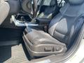 The interior of a 2017 Acura TLX showing the driver's seat with leather upholstery and controls for seat adjustments