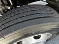 A close-up of a Hino 155 tire showing the tread pattern and rubber surface with visible wear and grooves