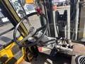 Interior view of a 1993 Hyster H80XL forklift showing the steering wheel and control levers with an overhead gauge