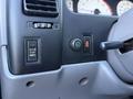 Control panel of a 2004 Toyota Tacoma featuring buttons for clutch start cancel and rear off lock alongside a dial for additional functions