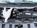 The engine compartment of a 2016 GMC Savana showing the engine assembly with various components including hoses and a coolant reservoir