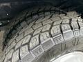 Close-up of the rugged tire tread of a 2001 Ford F-350 showcasing its deep grooves and robust design suitable for heavy-duty performance
