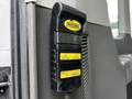 A black control panel with yellow buttons labeled Stow Deploy Up and Down used for operating a lift system in a vehicle