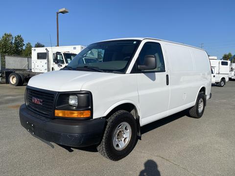 A white 2012 GMC Savana van with a black front grille and wheels parked on a lot