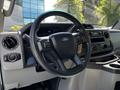 Interior view of a 2021 Ford Econoline showcasing the steering wheel dashboard and controls