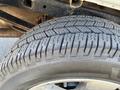 A close-up of a 2014 Ford F-150 tire showcasing the tread pattern and a portion of the wheel rim