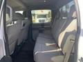 The interior of a 2017 Ford F-150 showing the back seat with fabric upholstery and seat belts visible