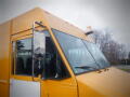 A yellow 2008 Freightliner MT45 Chassis with a prominent windshield side mirror and a roof light