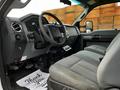 Interior view of a 2016 Ford F-550 featuring a gray dashboard steering wheel and seating with a patterned fabric design